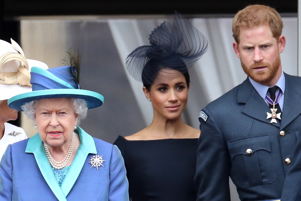 Königin Elizabeth II., Prinz Harry, Herzog von Sussex und Meghan, Herzogin von Sussex auf dem Balkon des Buckingham Palace, während die königliche Familie an Veranstaltungen teilnimmt, um das hundertjährige Bestehen der RAF am 10. Juli 2018 in London, England, zu feiern. 