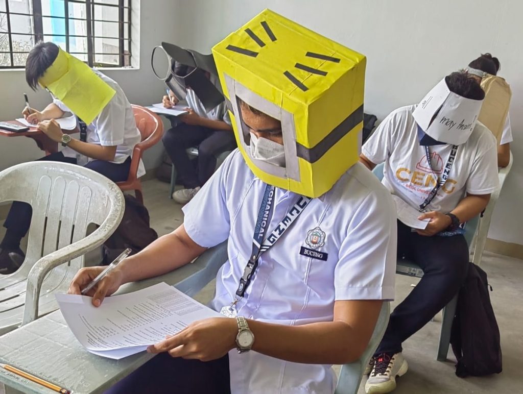 Es gibt Bilder von philippinischen Studenten, die Anti-Cheating-Hüte tragen