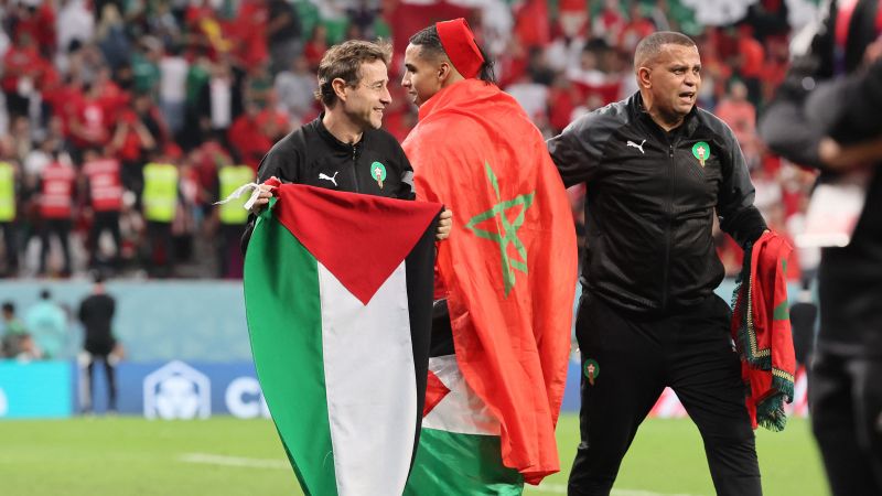 Eine palästinensische Flagge wird auf dem Spielfeld gehisst, während Marokko einen historischen WM-Sieg feiert